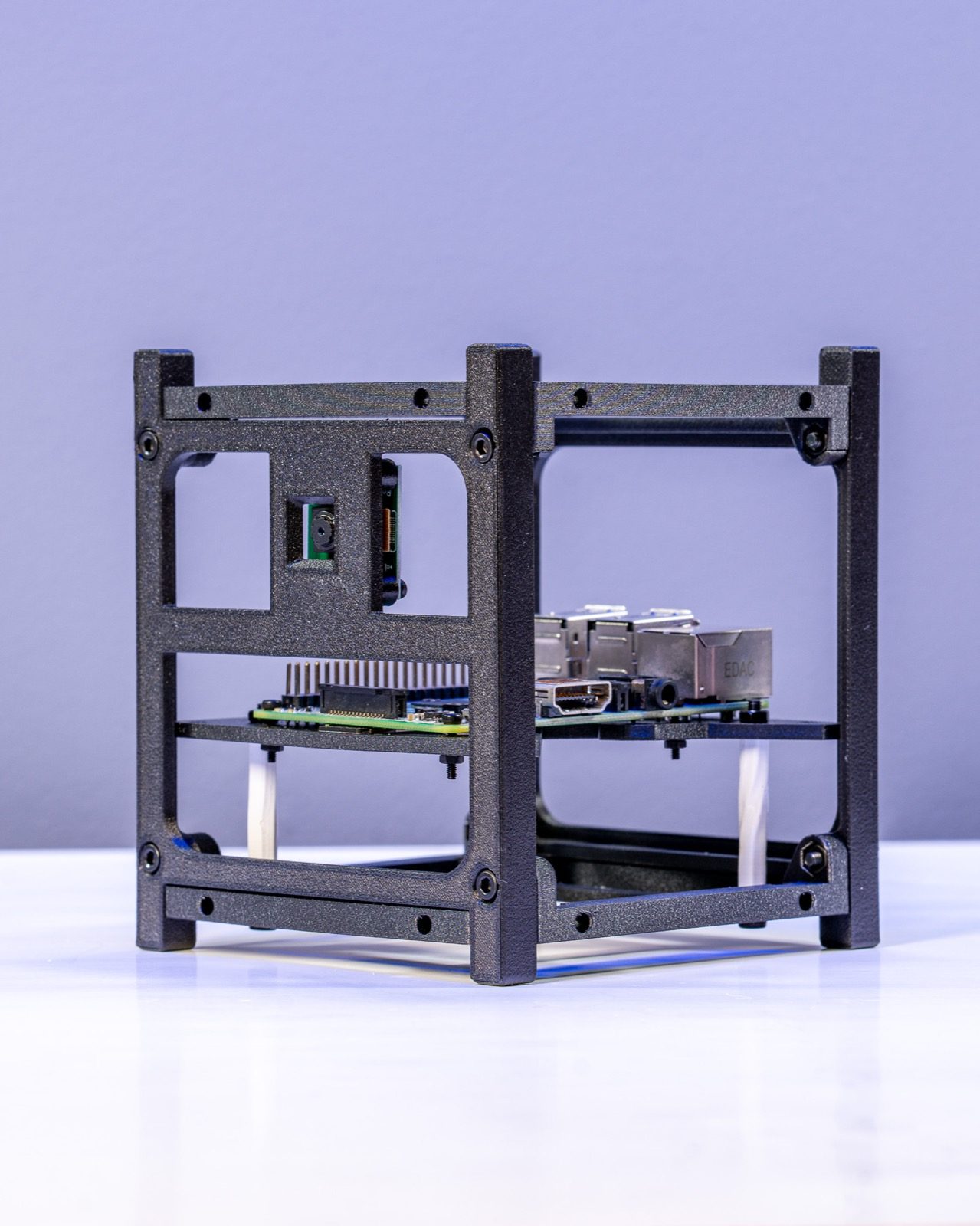 1U CubeSat test frame in recycled carbon-fibre PETG holding a Raspberry Pi and camera module